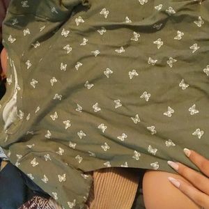 It's a darkish green with butterfly's on it